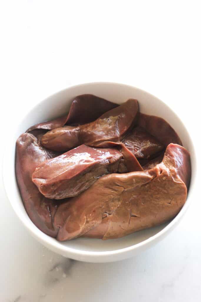 raw lamb livers in the white bowl