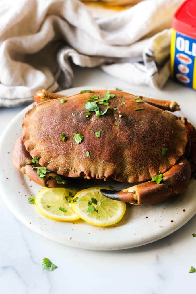 steamed rock crab on the plate with cilantro and lemon