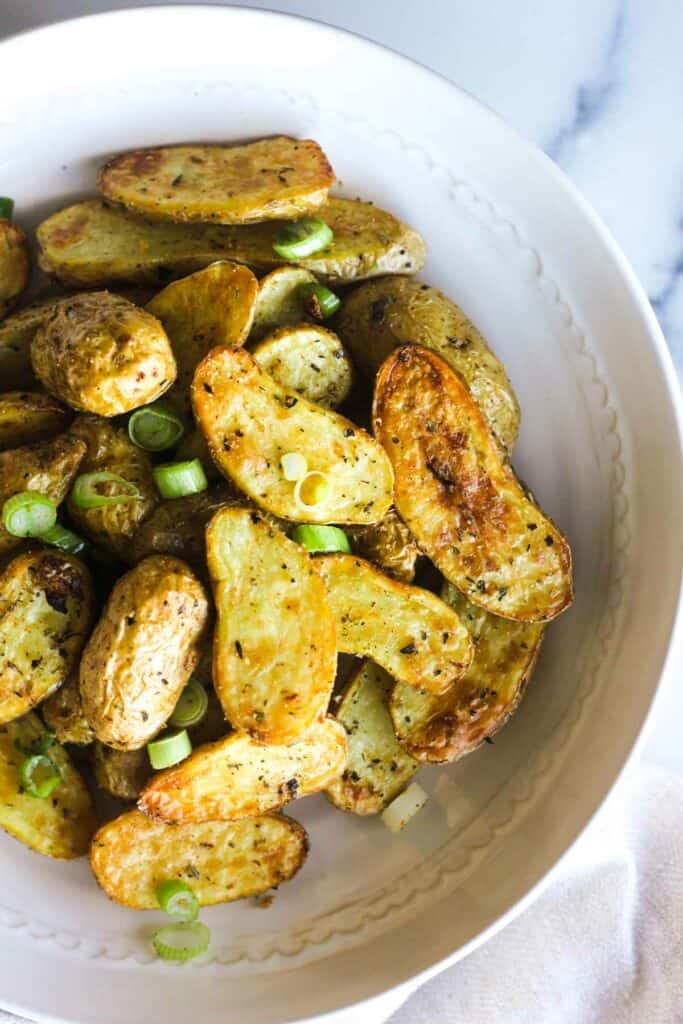 air fryer fingerling potatoes with chopped green onions on top