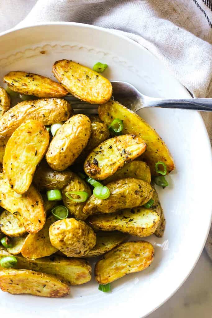 cooked small potatoes on a white plate