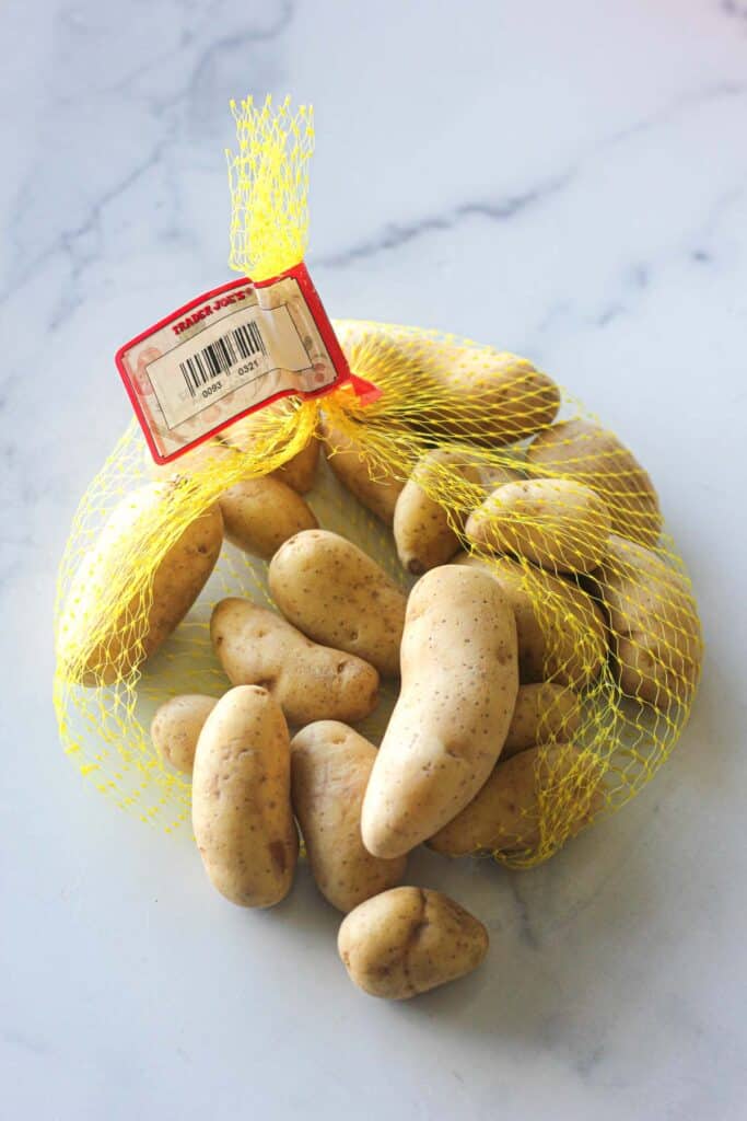 a bag of fingerling potatoes that will be cooked in ninja foodi air fryer