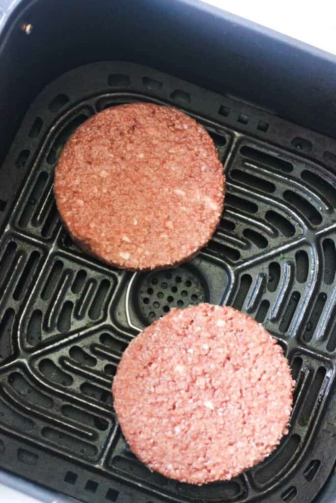 raw impossible burger patties in thte air fryer before cooking