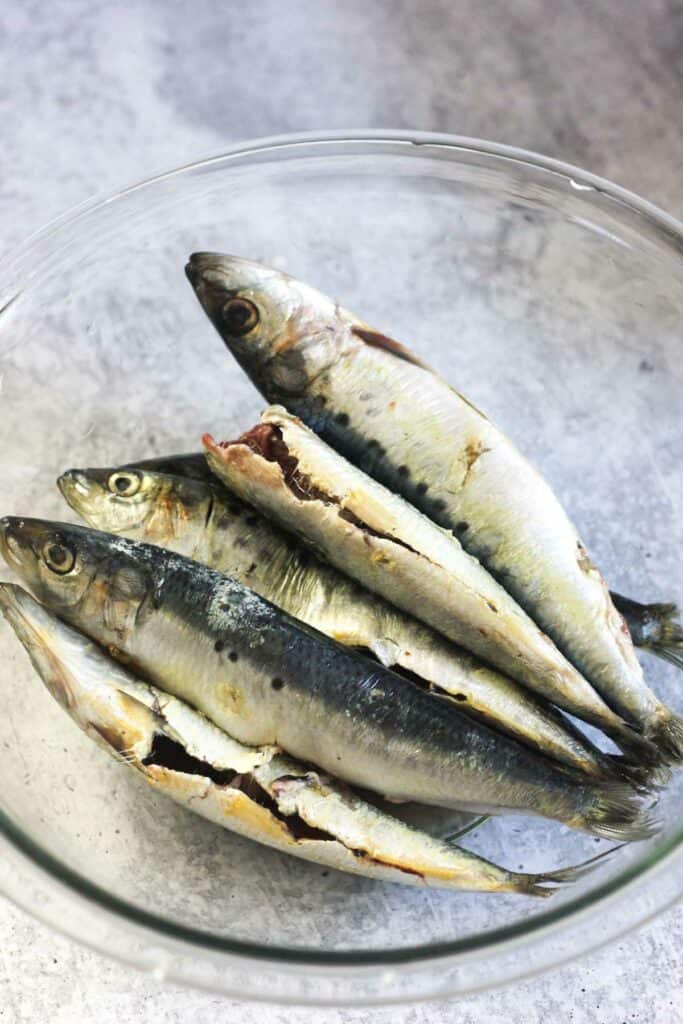 raw cleaned sardines in the clear glass bowl