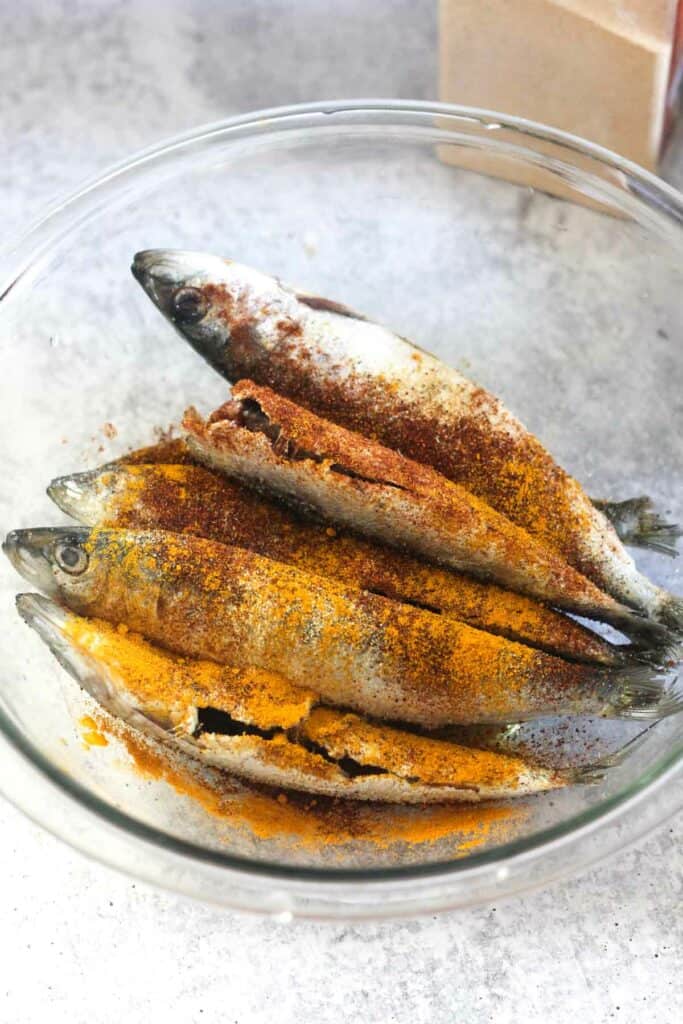 seasoned fish in the clear glass bowl