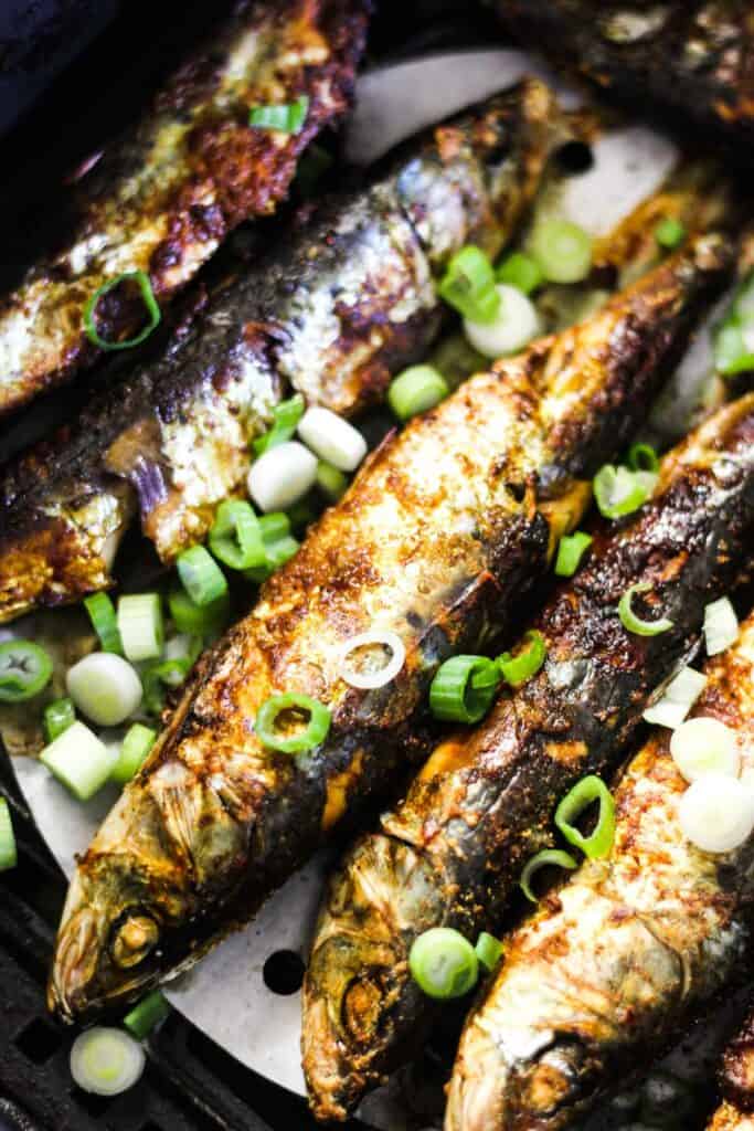 air fryer sardines with chopped scallions on top