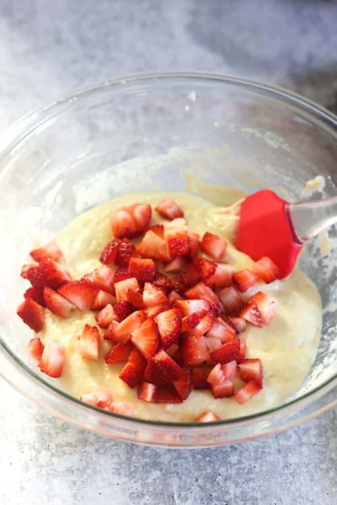chopped strawberries in the bowl with batter