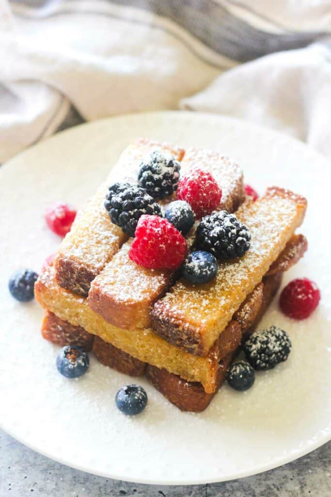 great value french toast sticks on the plate with powdered sugar and berries
