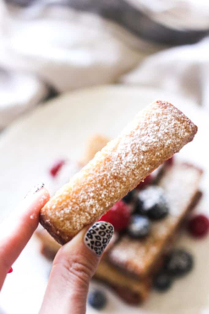 holding bread stick in fingers