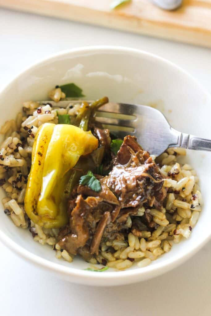 london broil with ranch dressing in the small bowl with rice