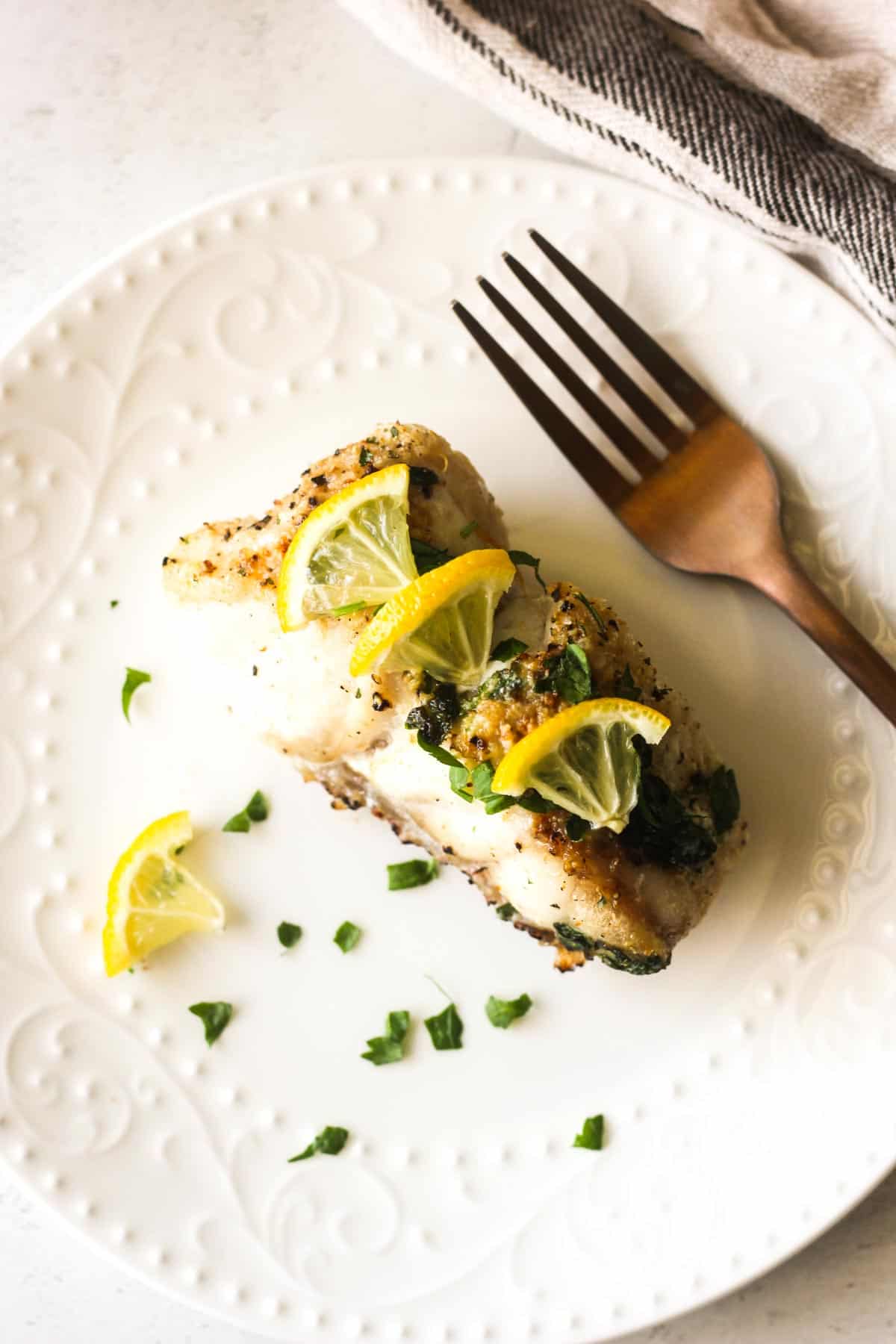 cooked grouper filet in the air fryer served on the white plate