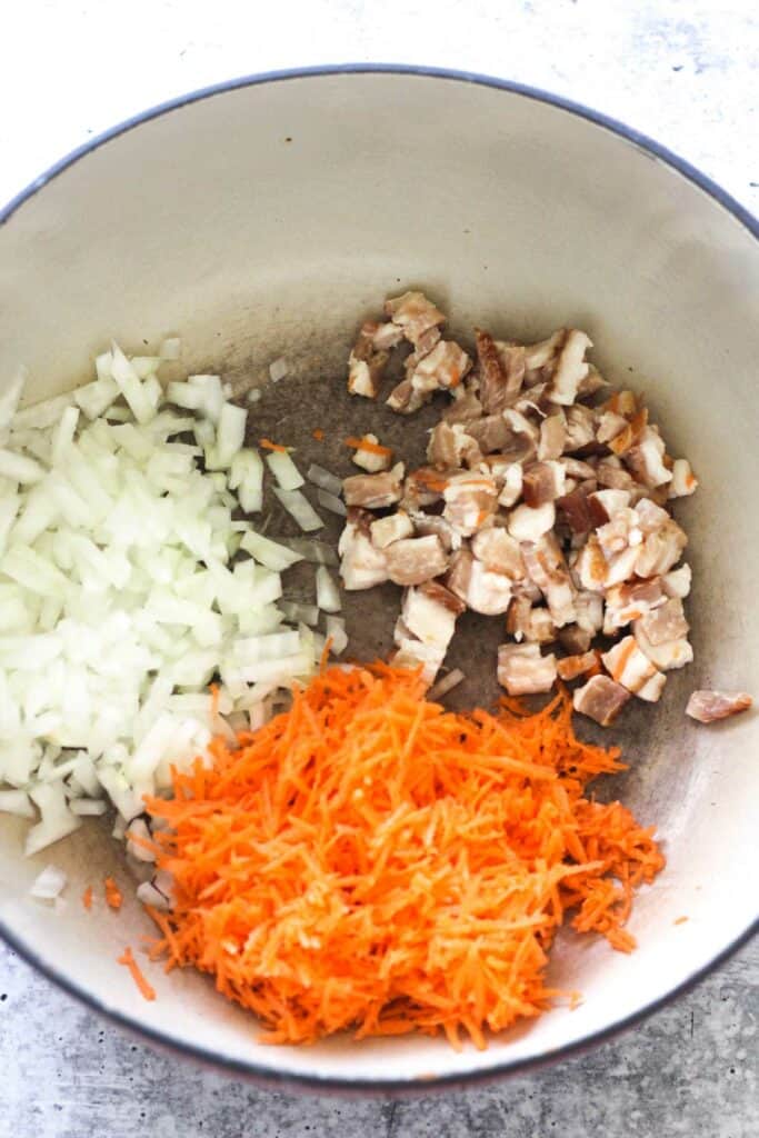 chopped bacon, onions and shredded carrots in the heavy bottom pot