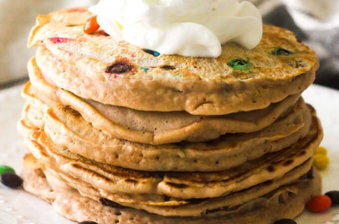 breakfast with candies, pancakes and whipped cream
