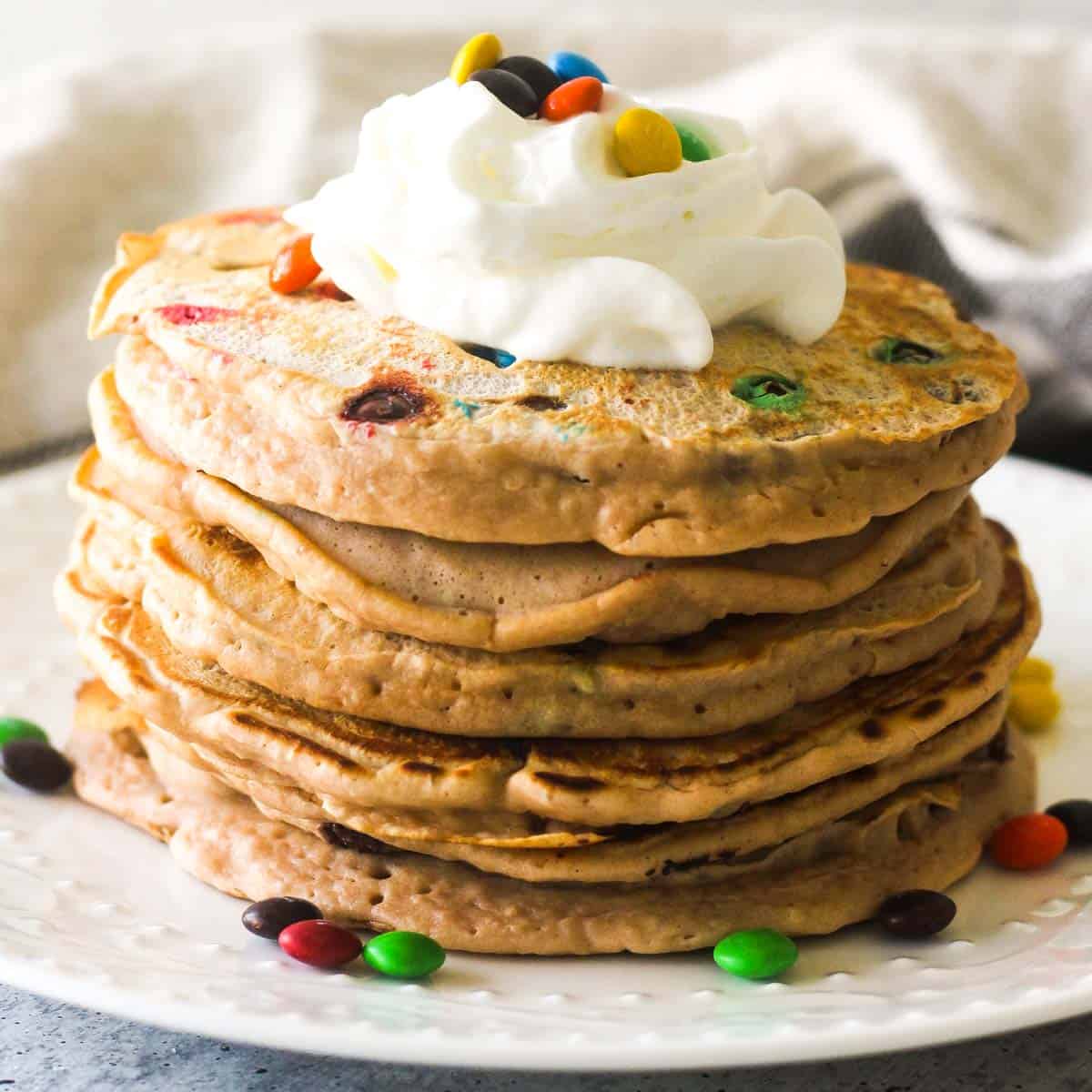 breakfast with candies, pancakes and whipped cream