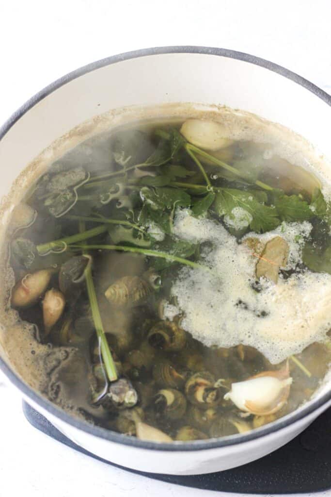 cooked broth with snails in it