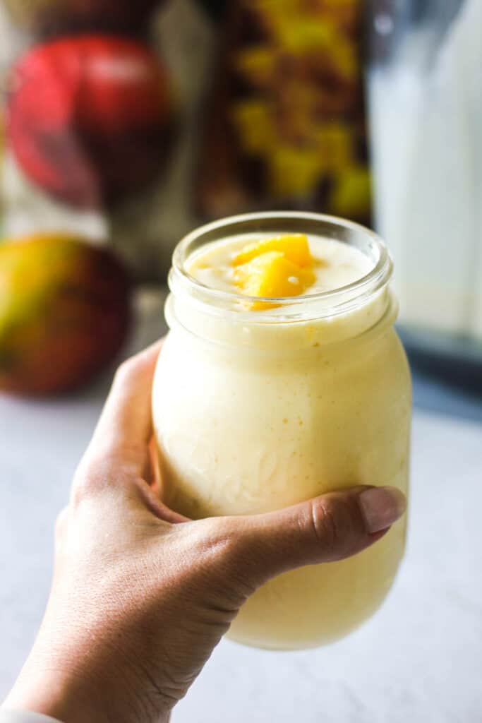 pineaplle mango lassi in the jar in hand