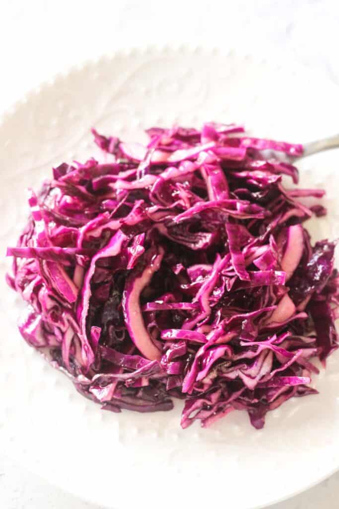 a white plate full of turkish red cabbage salad