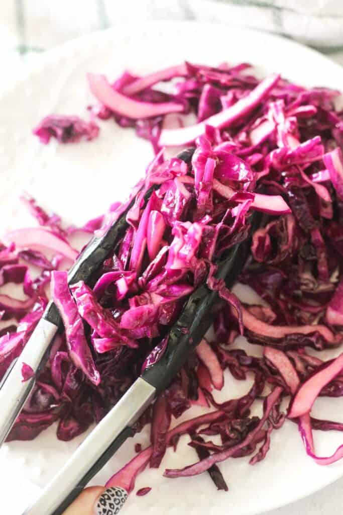 turkish red cabbage salad picked with tongs