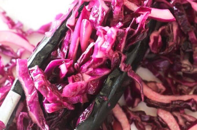 marinated red cabbage salad picked with tongs
