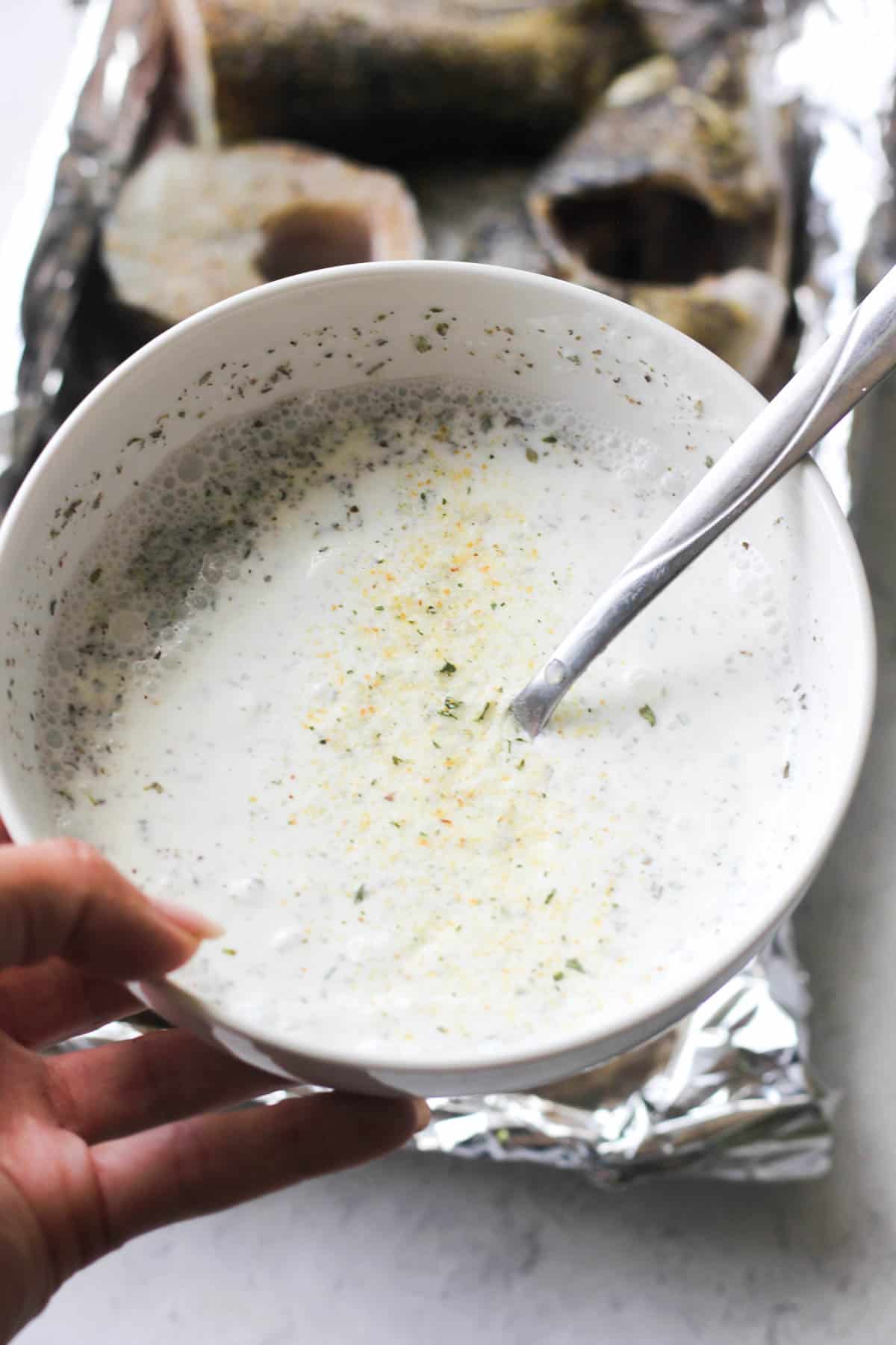 sour cream, water and oregano sauce in the bowl