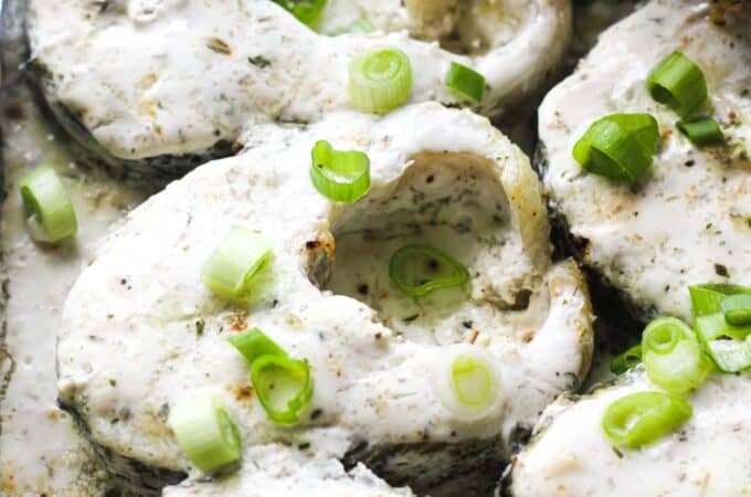 baked pike steaks covered in sour cream mixture
