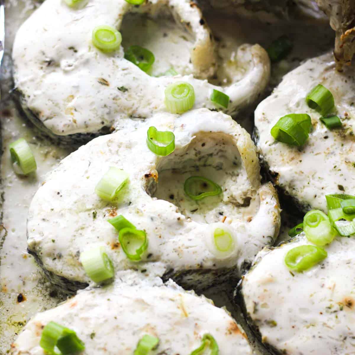 baked pike steaks covered in sour cream mixture