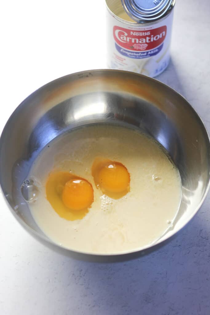 two raw eggs and batter in the bowl