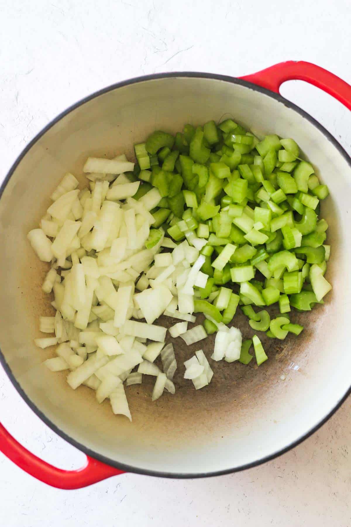 chopped celery and onion in the red pot