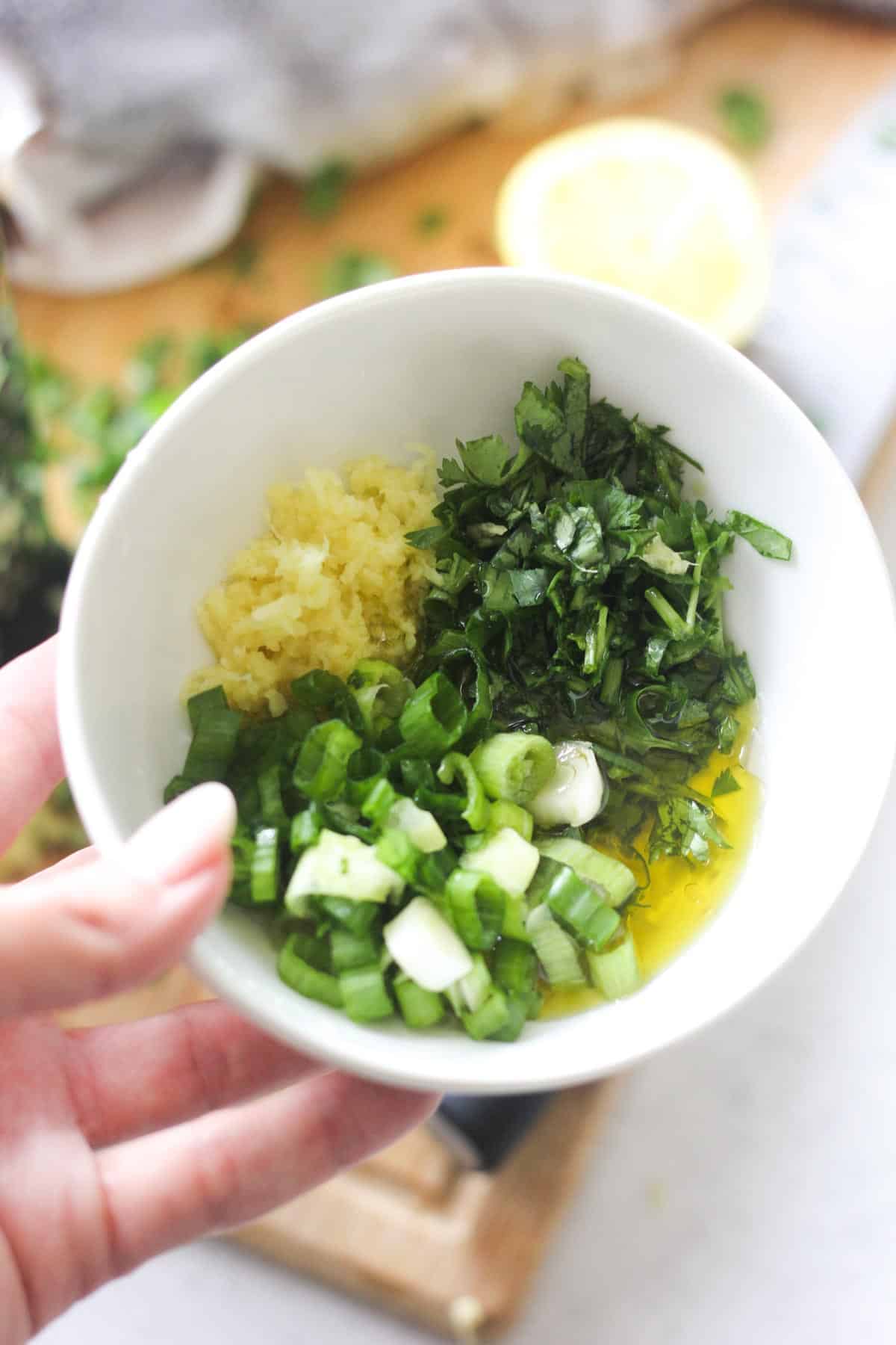 mixing dressing for the fish in the small bowl