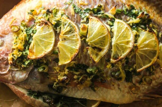 cooked whole red tilapia with lemons