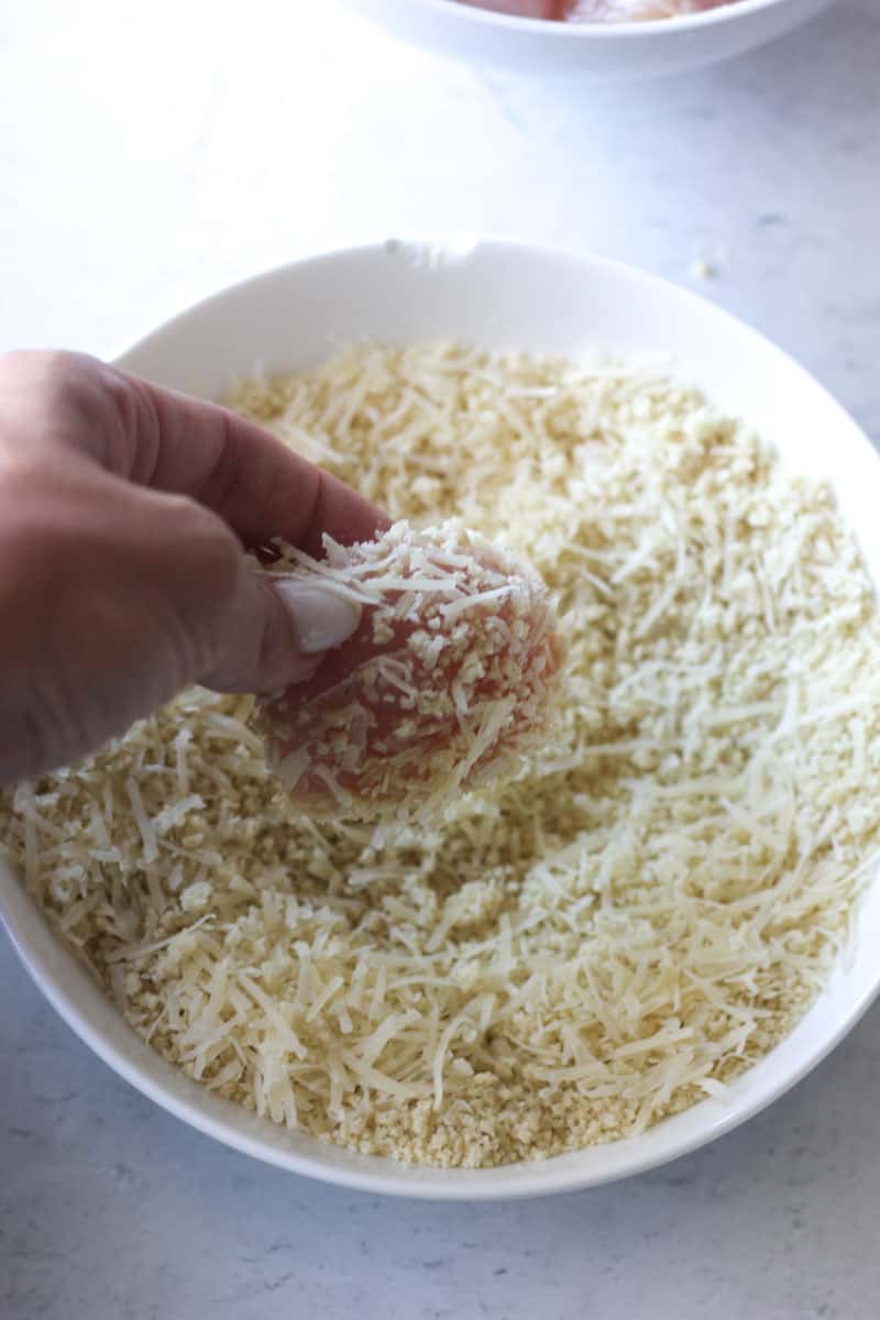 dredging turkey pieces in panko and shredded parmesan