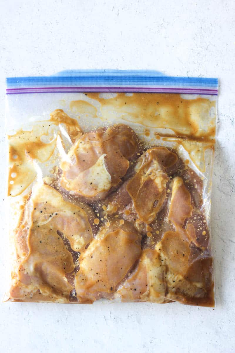 chicken with seasoning and marinade in the bag