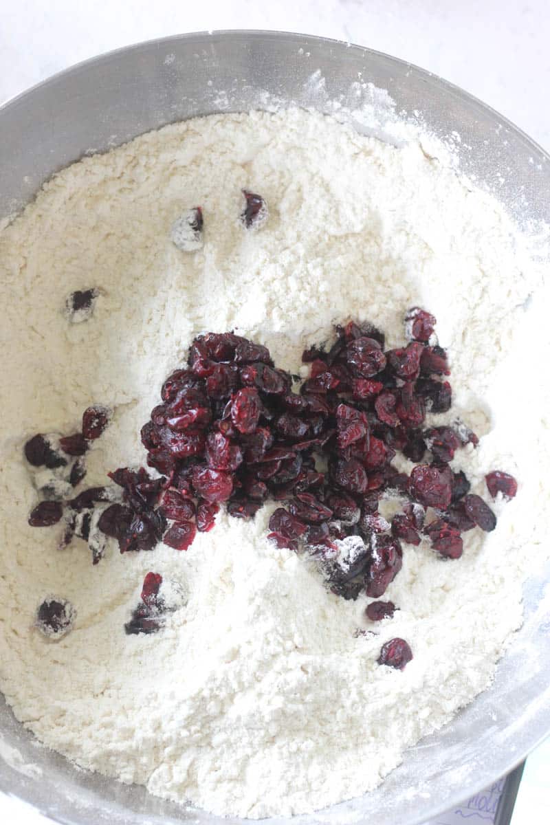 adding crenberries to the flour