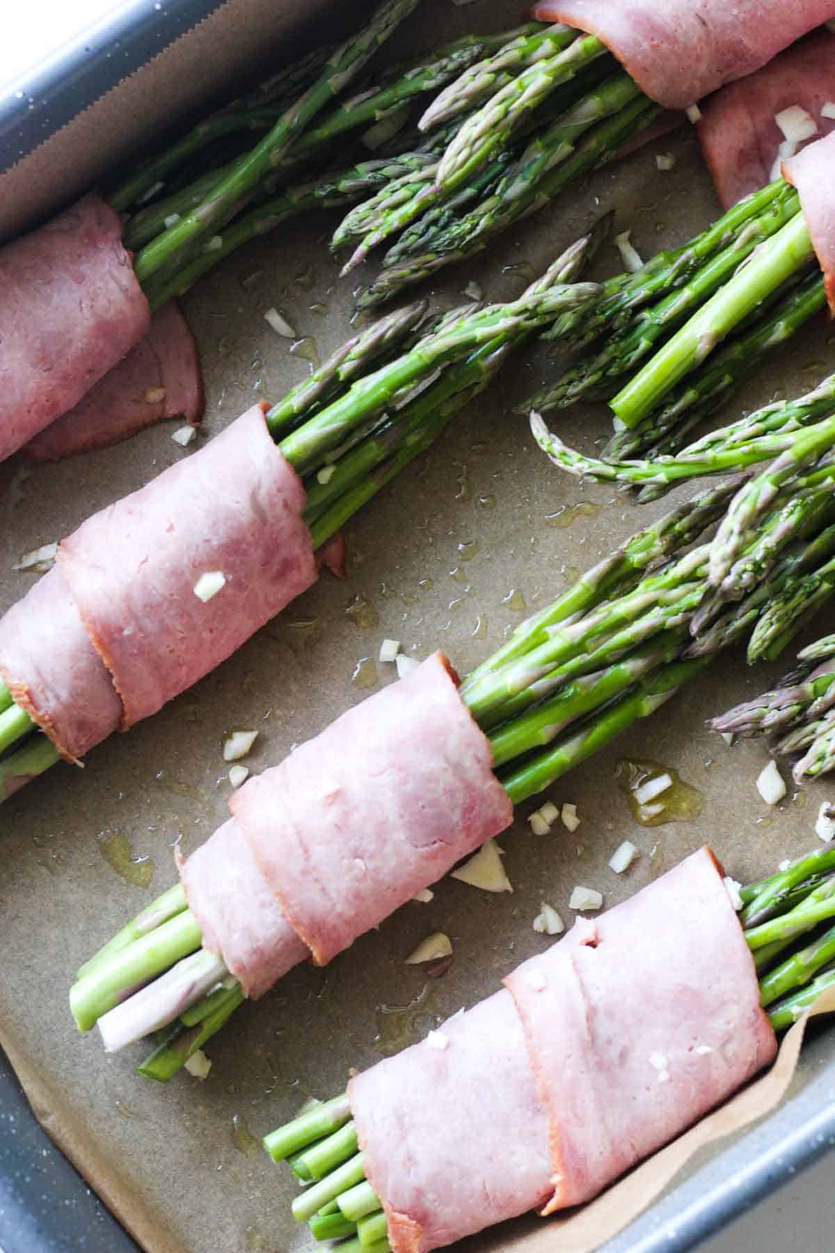 preparing asparagus wrapped in turkey bacon