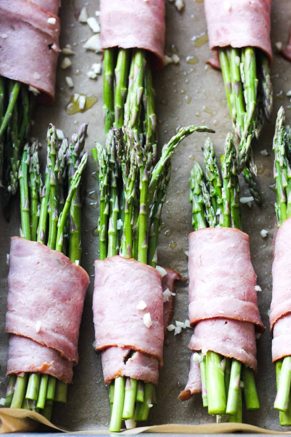 baking tray with asparagus, turkey bacon and garlic