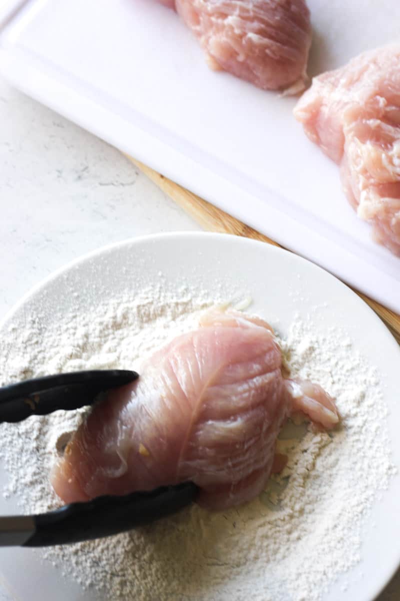 dipping poultry meat in to a flour