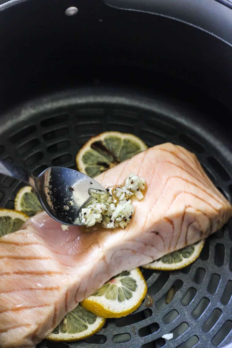 adding seasoning mixture to the salmon fillets