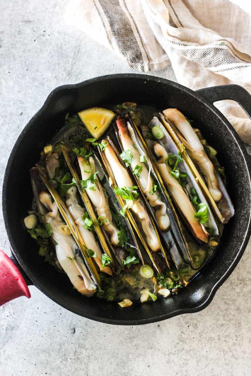 cookiing razor clams spanish style with garlic and parsley