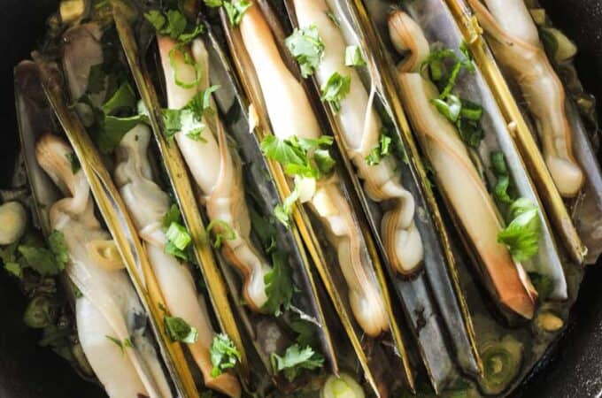 sauteed razor clams with garlic oil and green onions and lemon