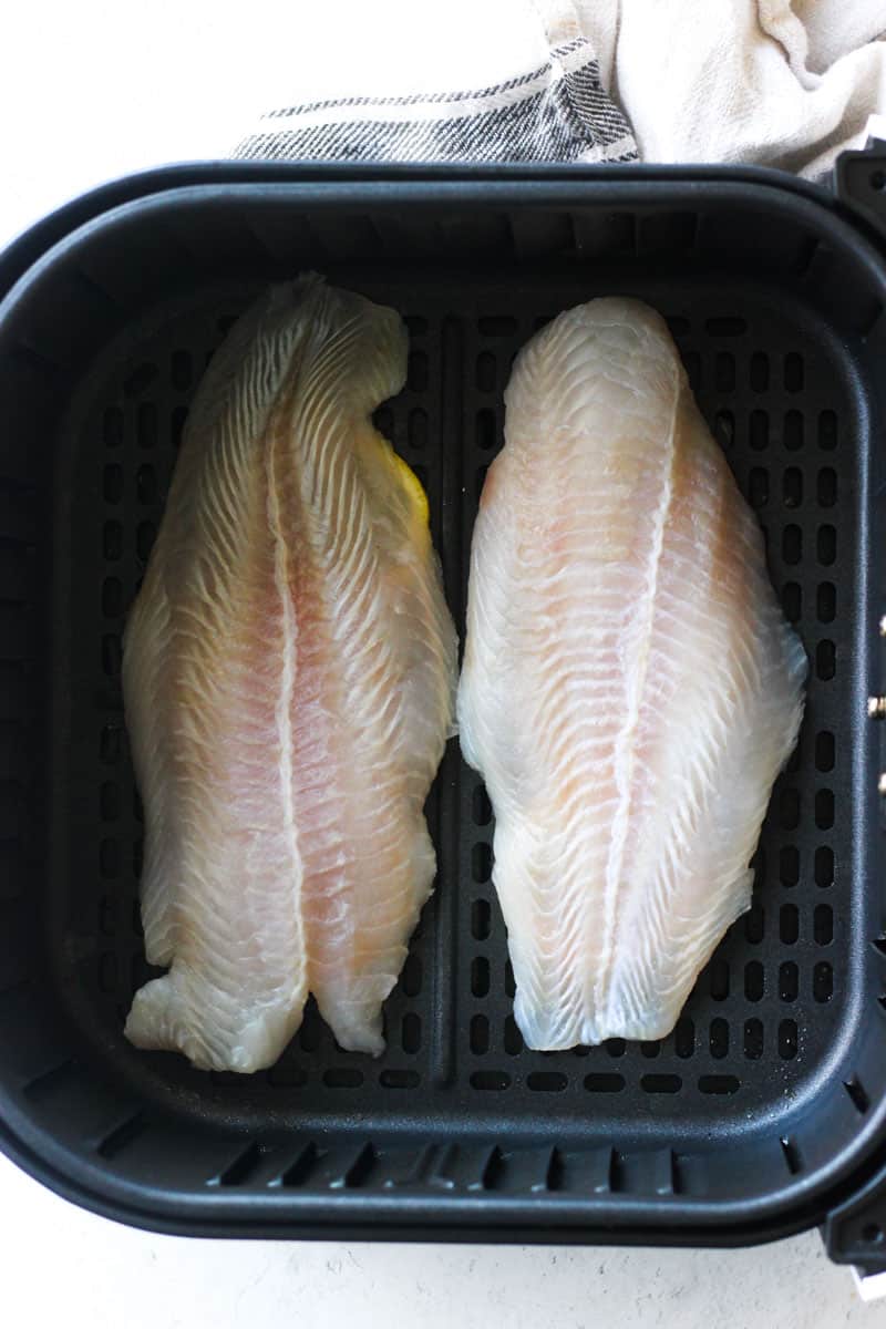 raw swai fish fillets in the air fryer basket