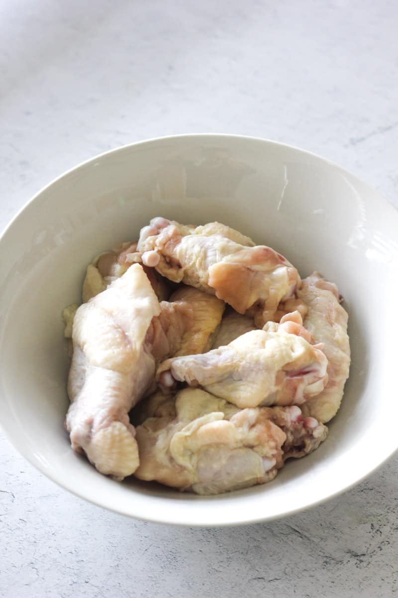 raw thawed chicken wings in the bowl