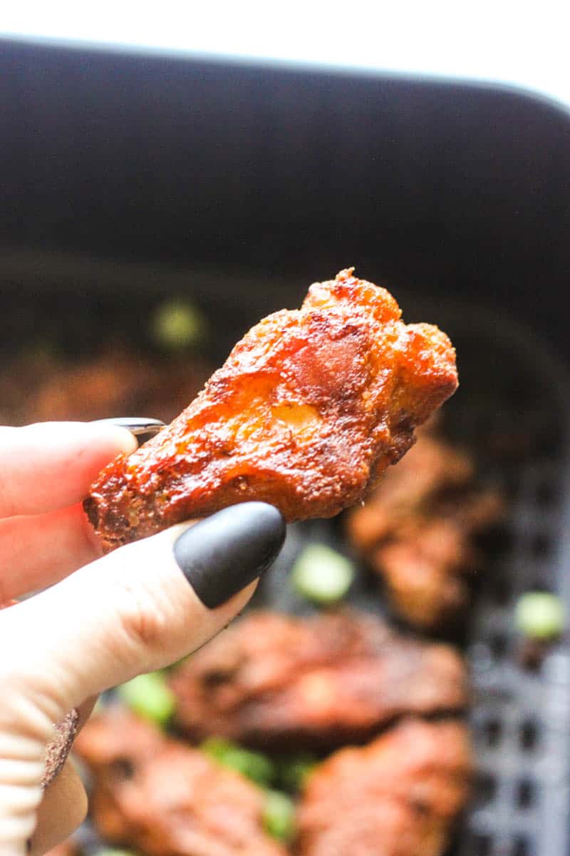 a piece of juicy wing in hand