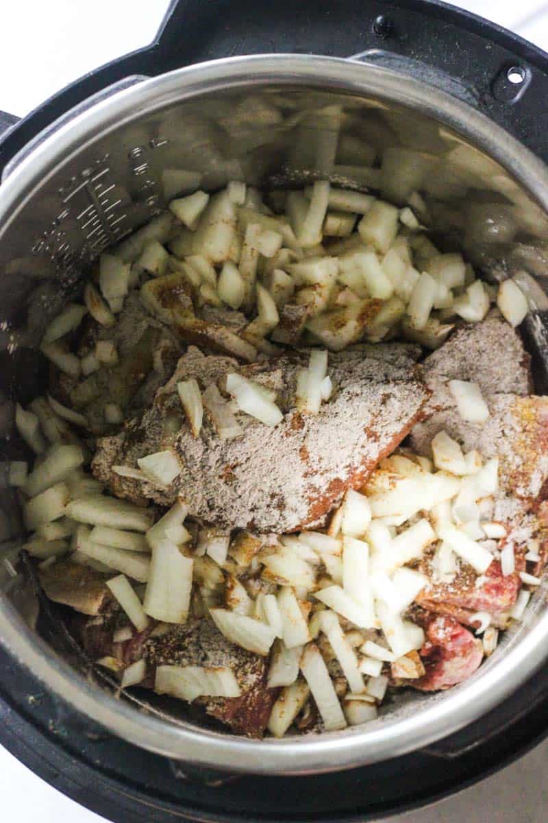 chopped onions and pork neck bones in instant pot
