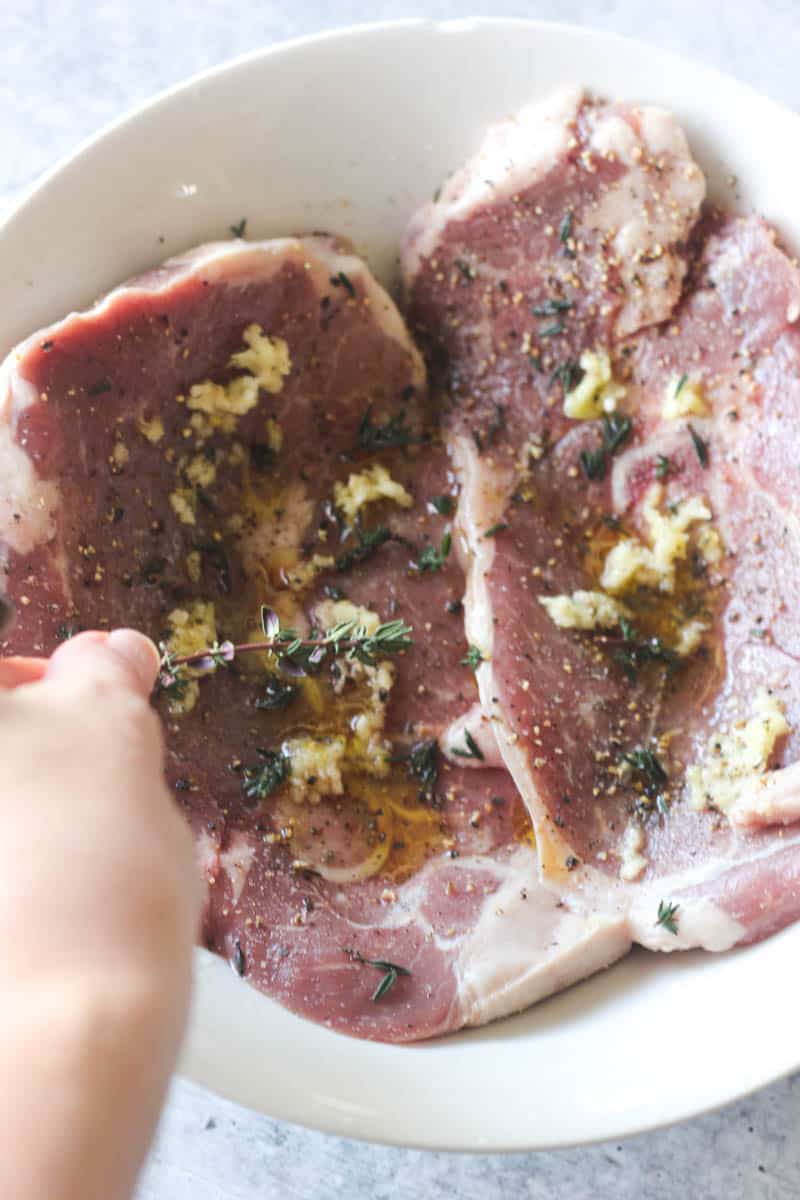 raw meat with thyme and garlic