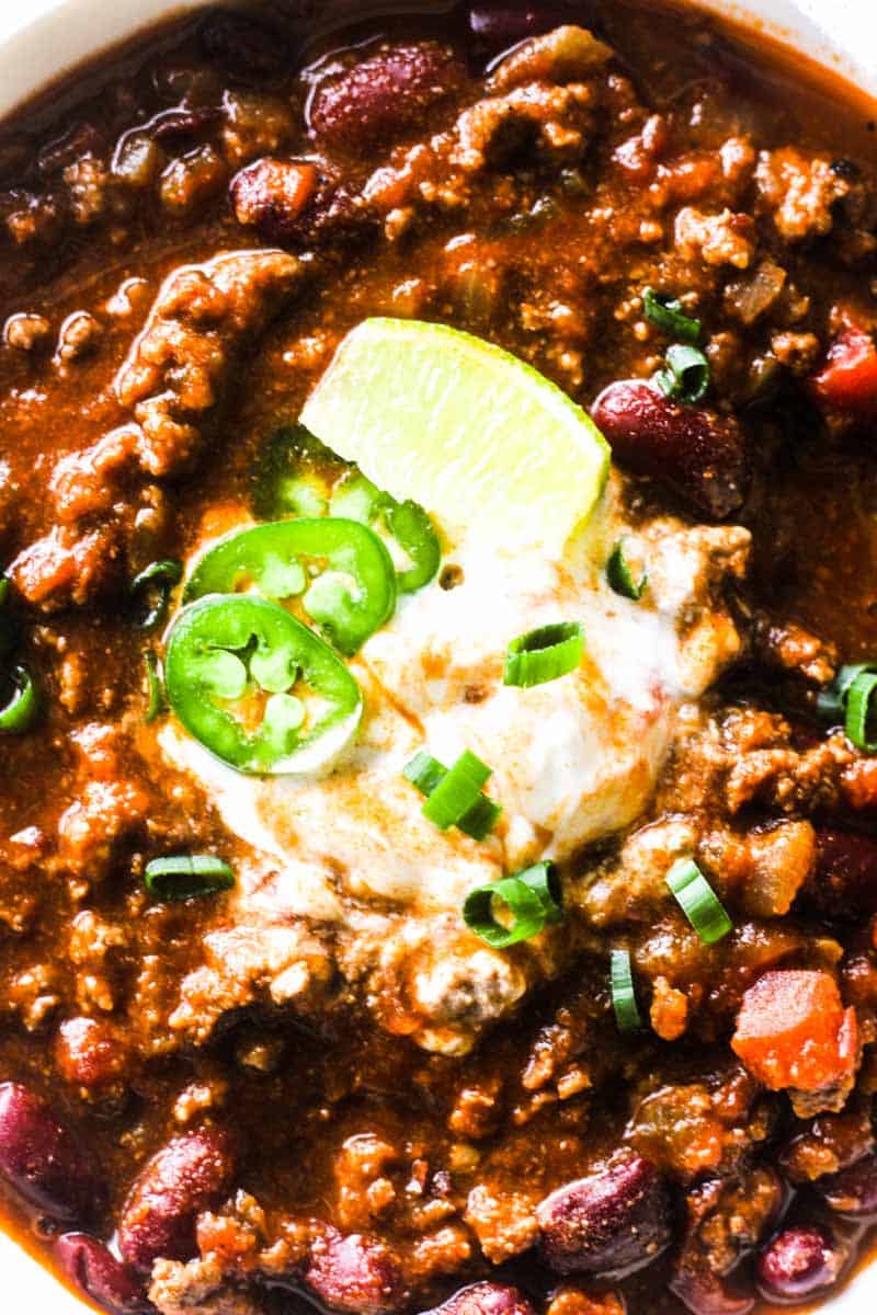 elk chili with sour cream and green onions