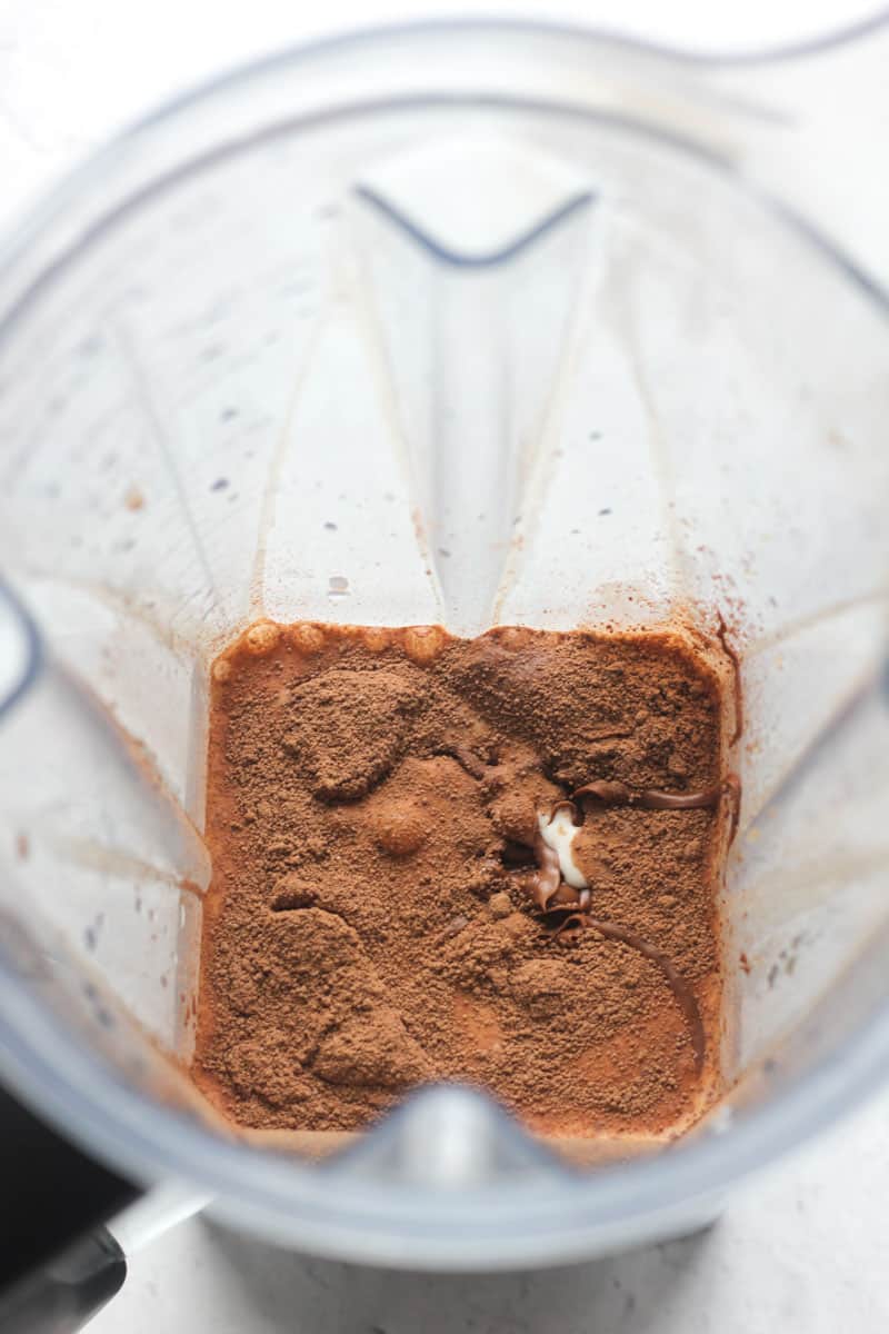 adding cocoa powder and milk in to the blender