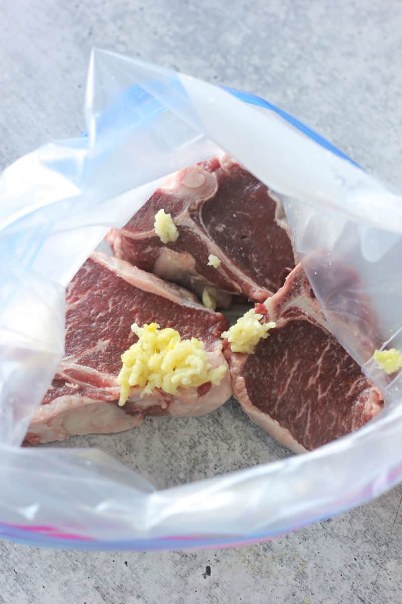 marinating meat with spices in a a zip lock bag