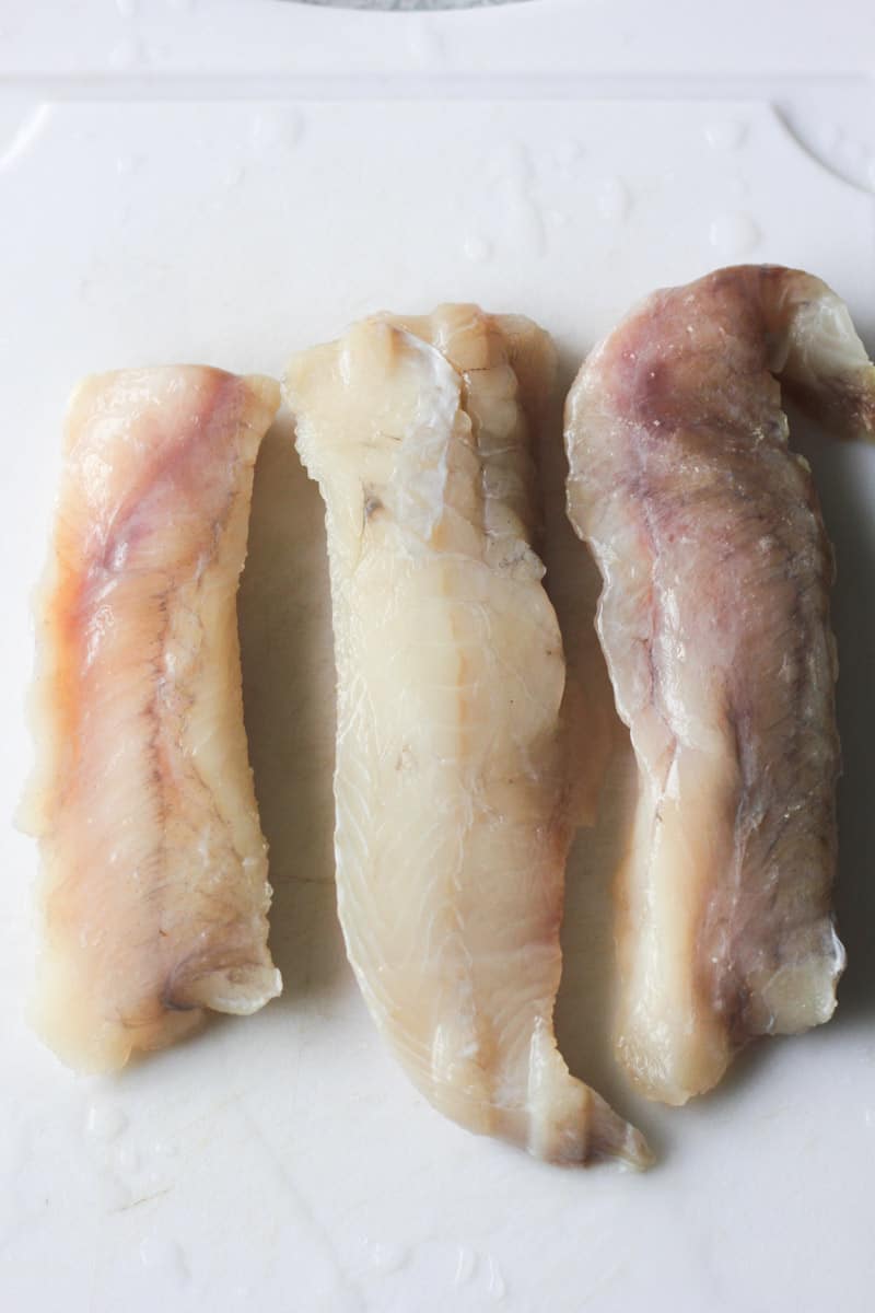 raw monkfish fillets on the cutting board