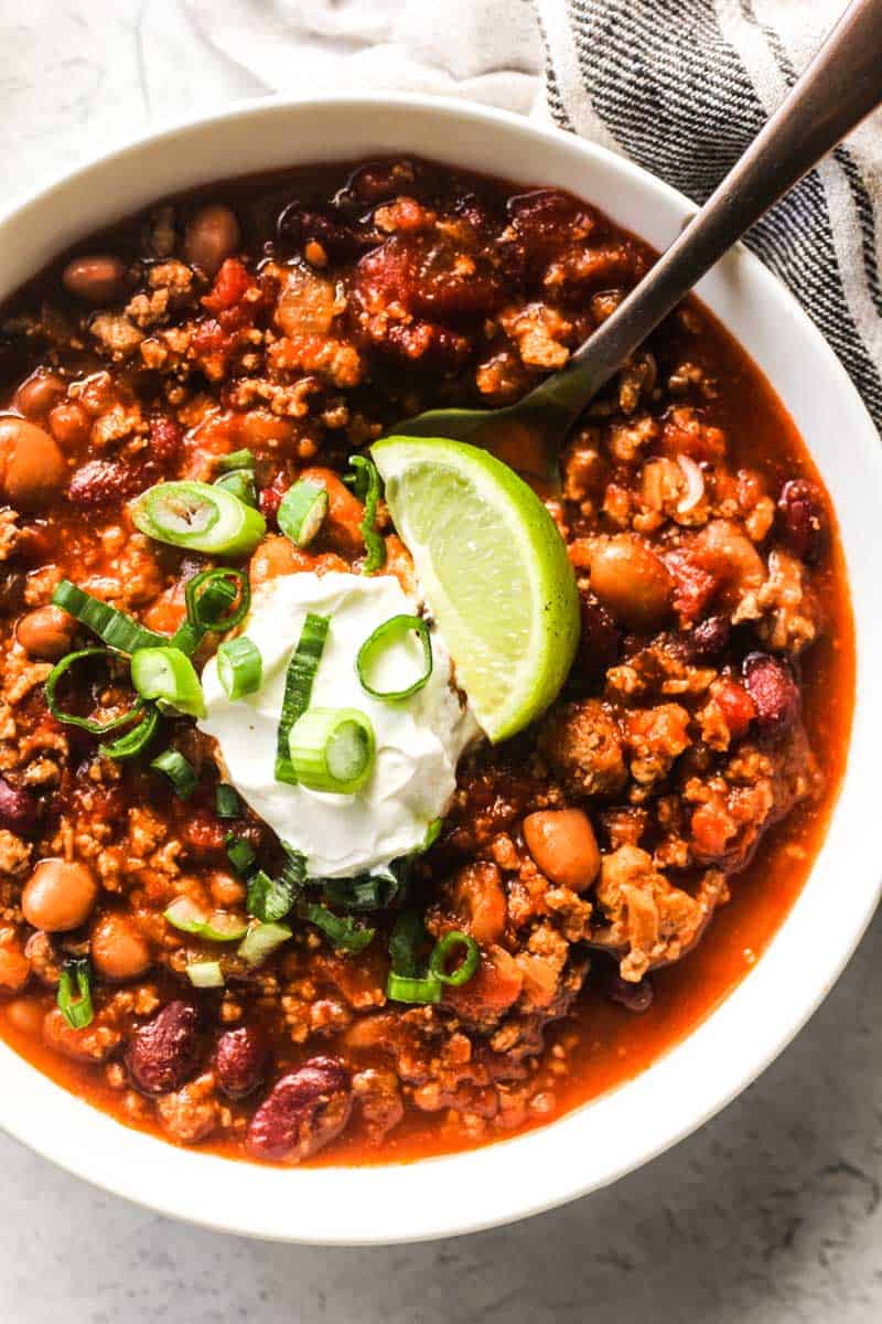 ground wild boar chili with sour cream and lime on top