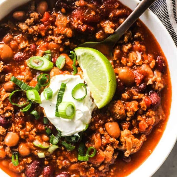 ground wild boar chili with sour cream and lime on top