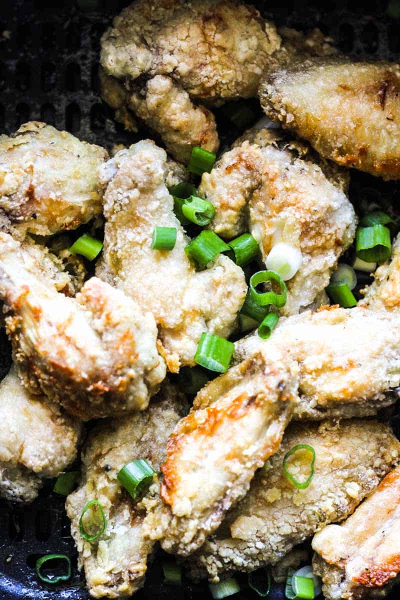 air fryer salt and pepper chicken wings with chopped green onions on top